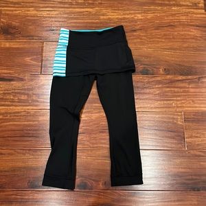 Lululemon black and blue leggings size 4 with skirt overlap.